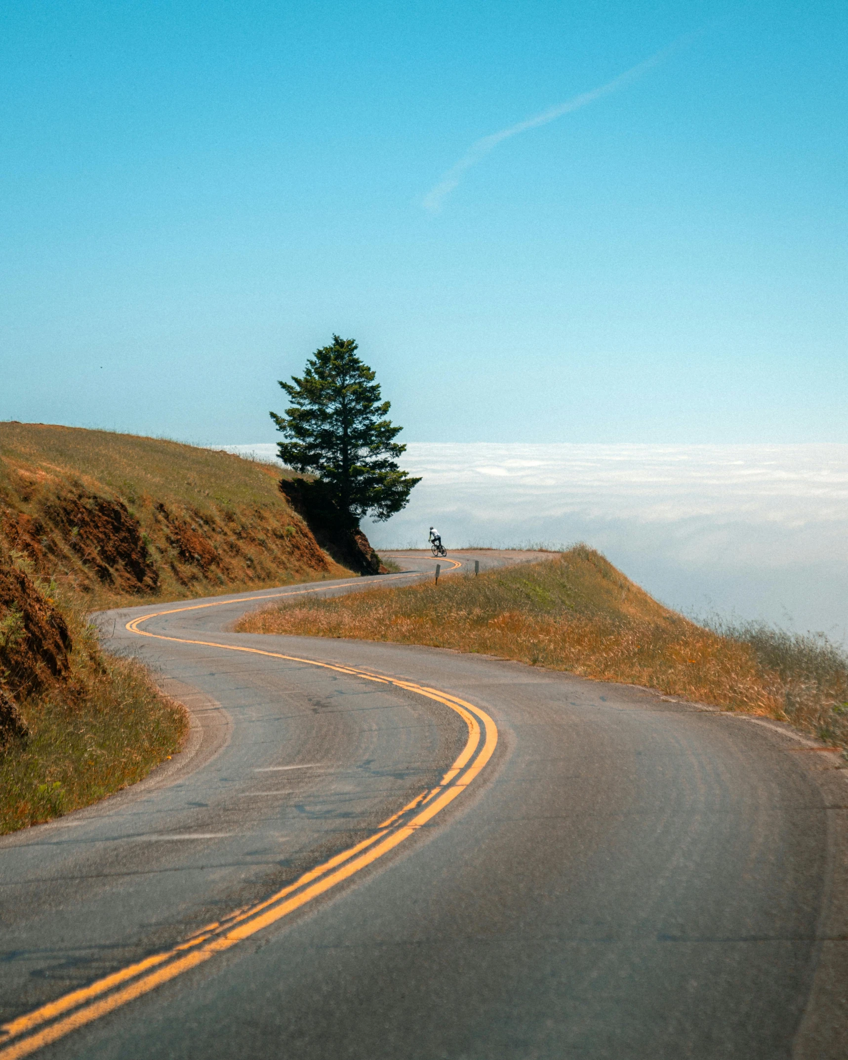 the road winds its way toward the top of the mountain