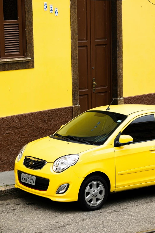 an image of a yellow car parked in front of a house