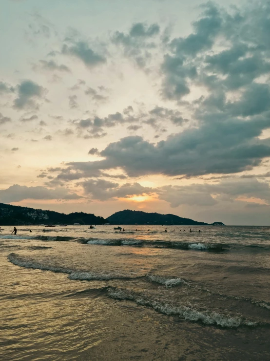 a person walking on the shore of a beach