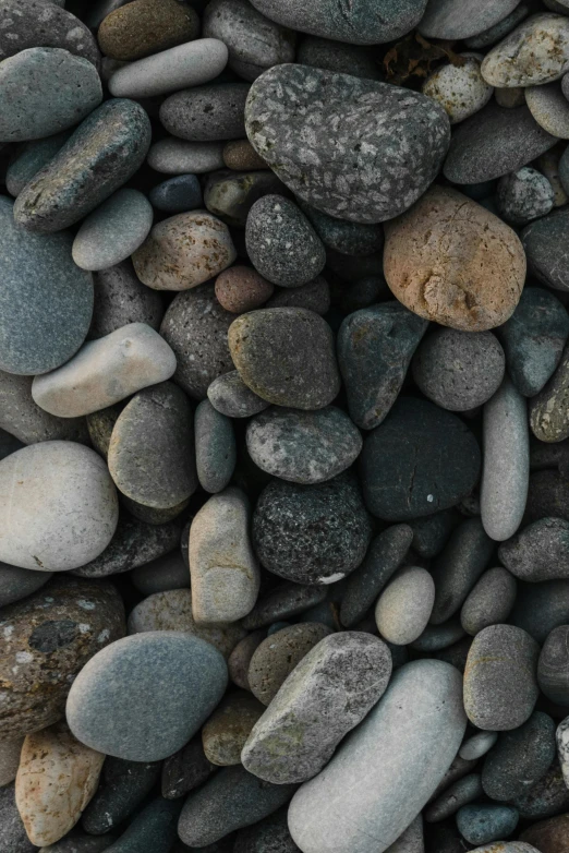 pebbles and rocks are mixed together and stacked in an irregular pattern