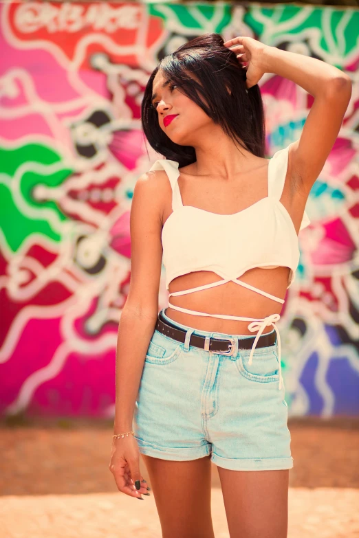 a woman with a white tank top posing for the camera