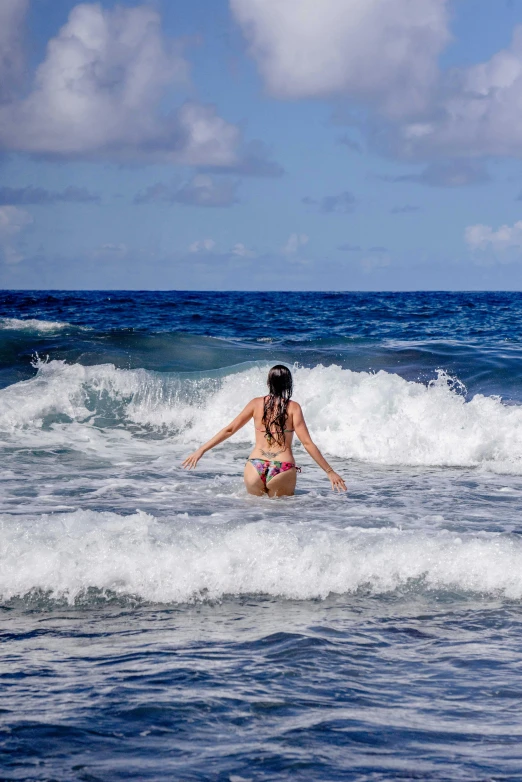 a woman in a bikini on a surfboard in the ocean