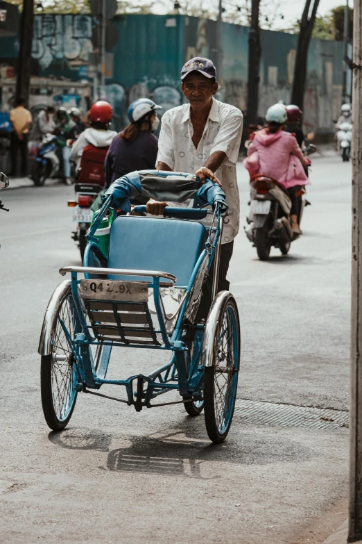 a man hes a bicycle in traffic along the road