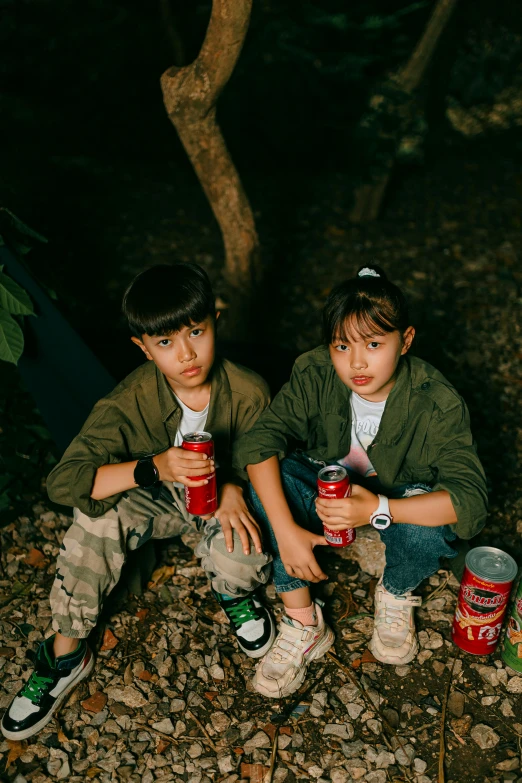 two boys are sitting down with their drinks