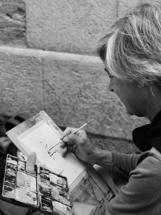 black and white image of a woman writing