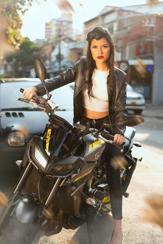 a woman sitting on top of a motorcycle