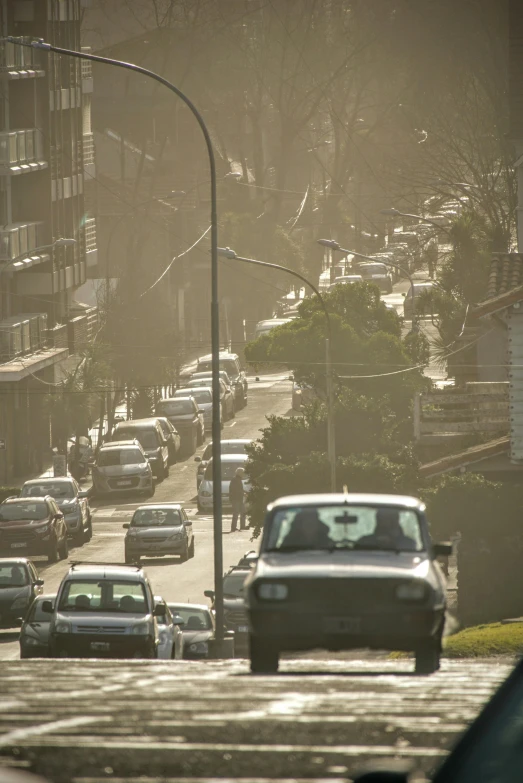 cars driving on the busy road near some apartment buildings