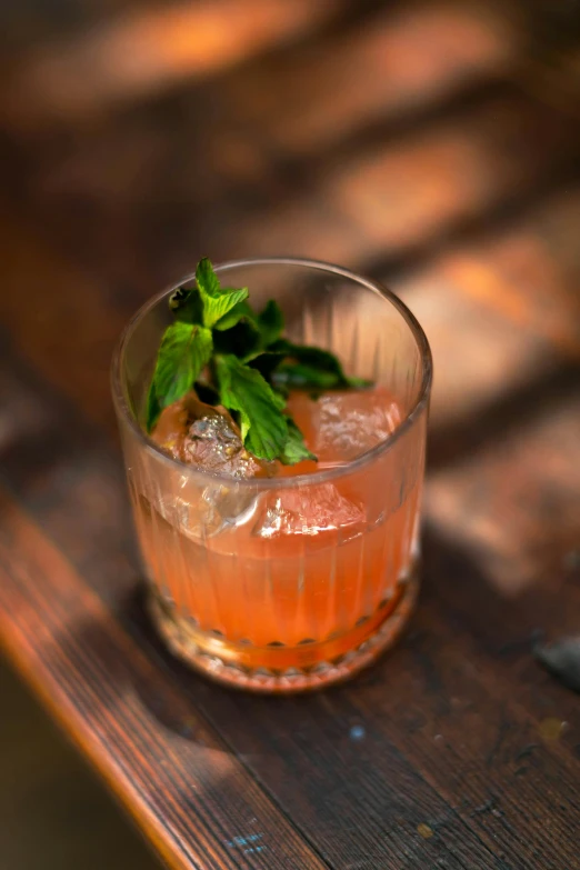 a tall drink sitting on top of a wooden table