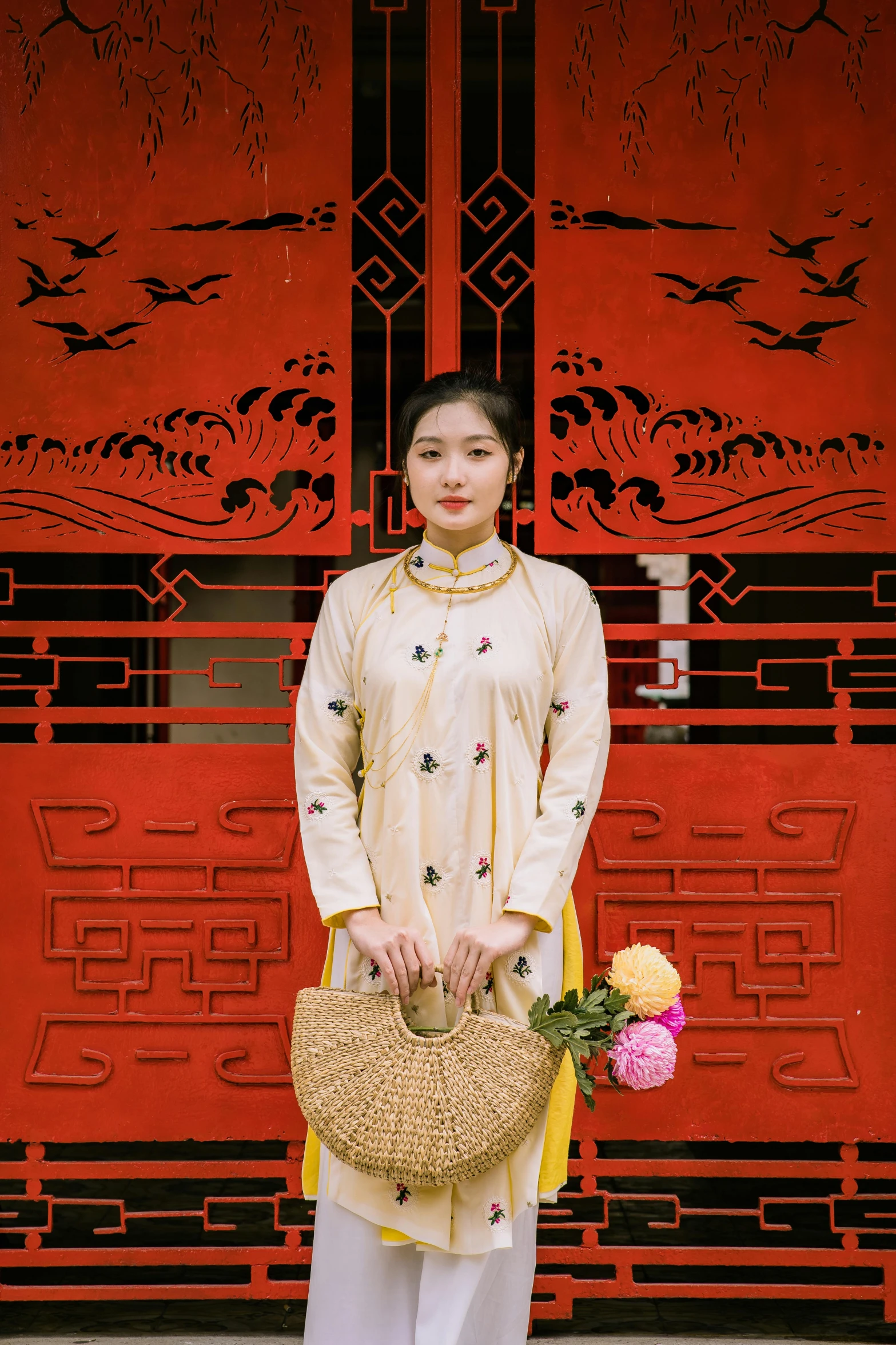 a young woman is wearing a traditional vietnamese outfit