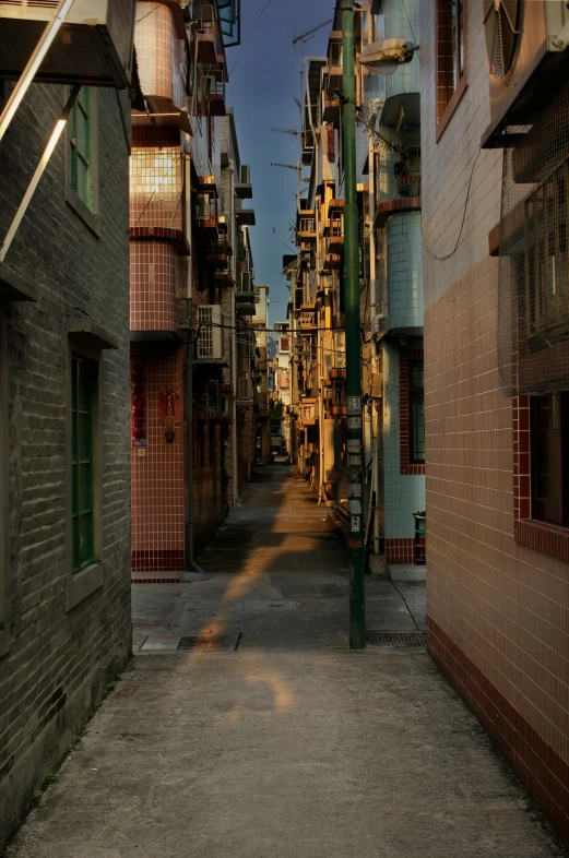 the shadow of people walking down a alley way in a town