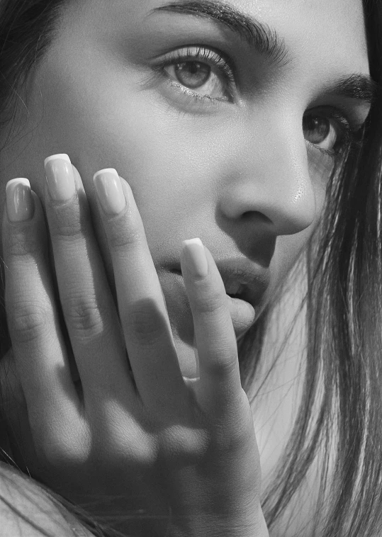 a woman's face is shown with her hands up