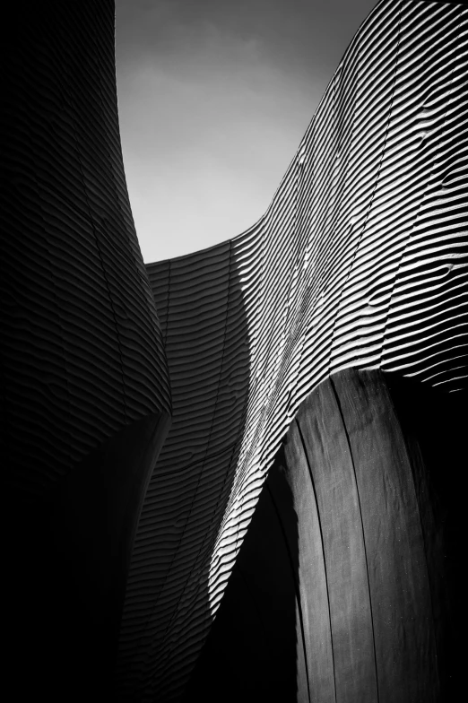 a black and white image of a curved building