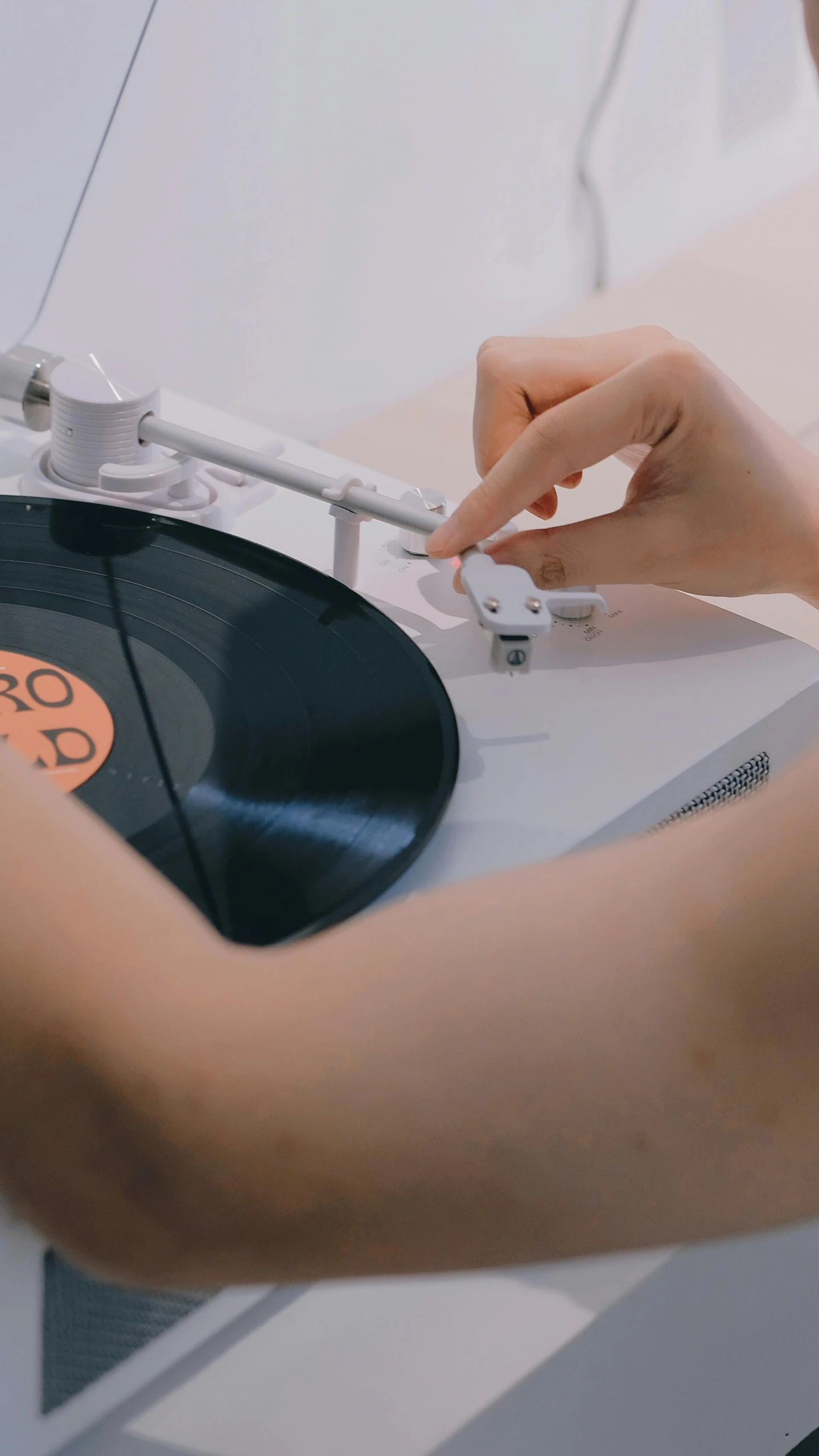 person using a record player to record songs