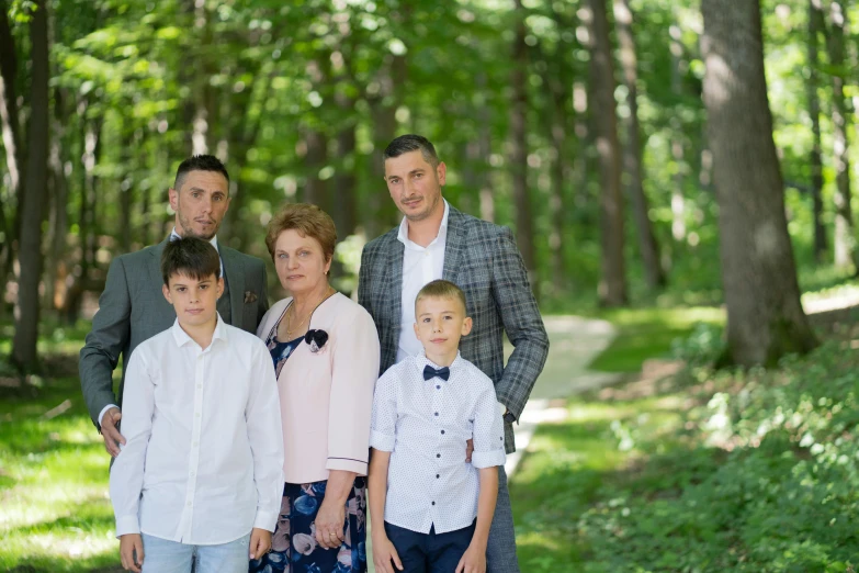 three adults and a child in the woods