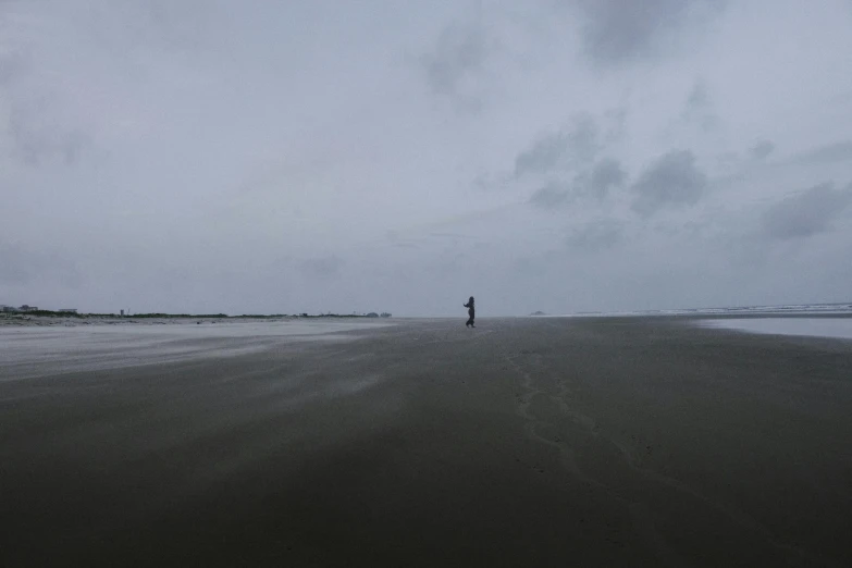 the person is standing alone on the beach