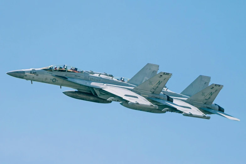 a jet with four people sitting on it's wings