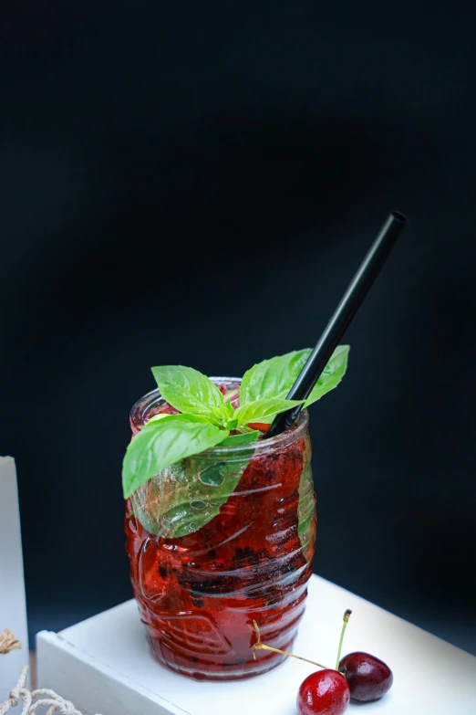 a drink with cherries on a white table