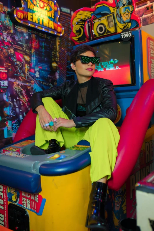 a person with sunglasses and sitting on a brightly colored play area