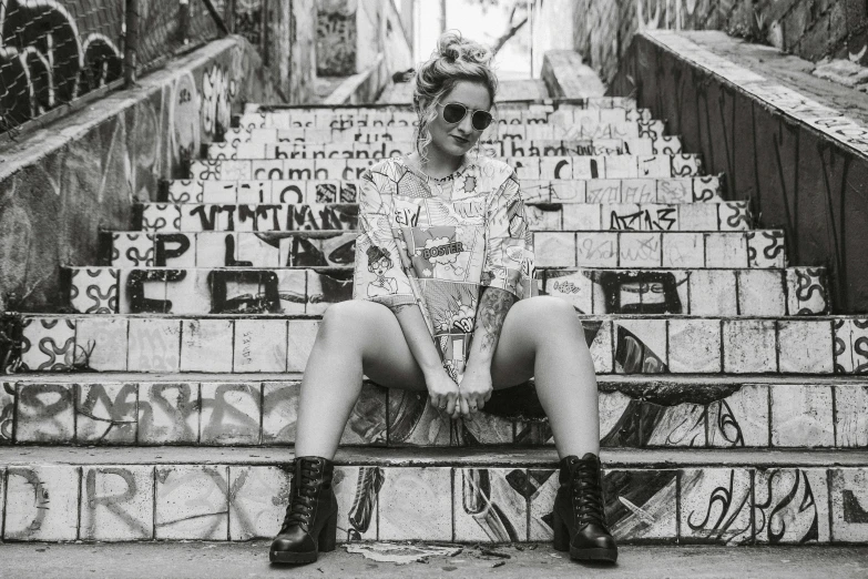 black and white pograph of woman sitting on steps