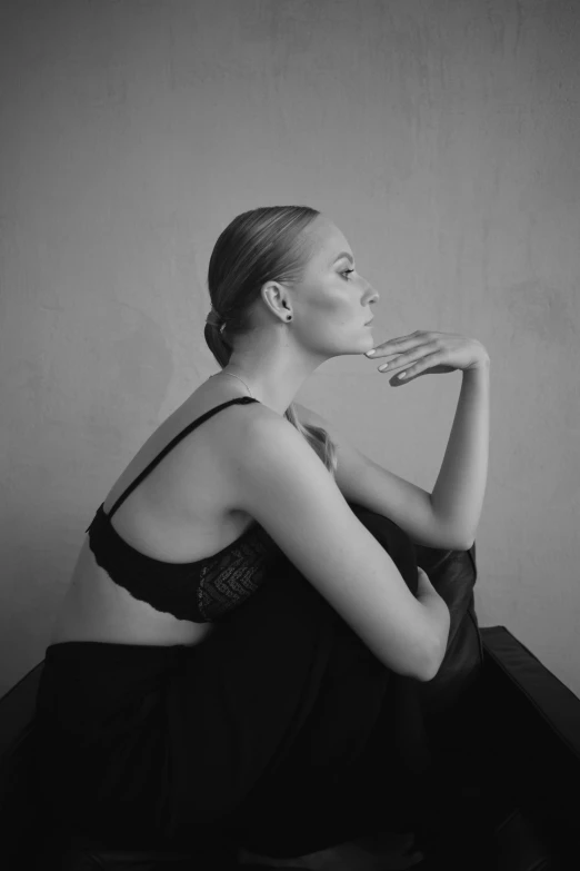 a woman sitting on the floor next to a wall