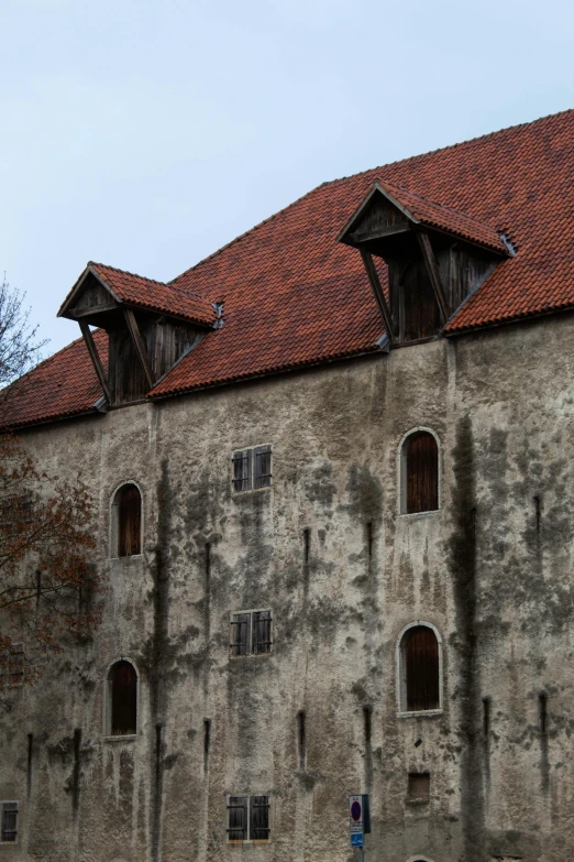 an old grey stone building with many windows