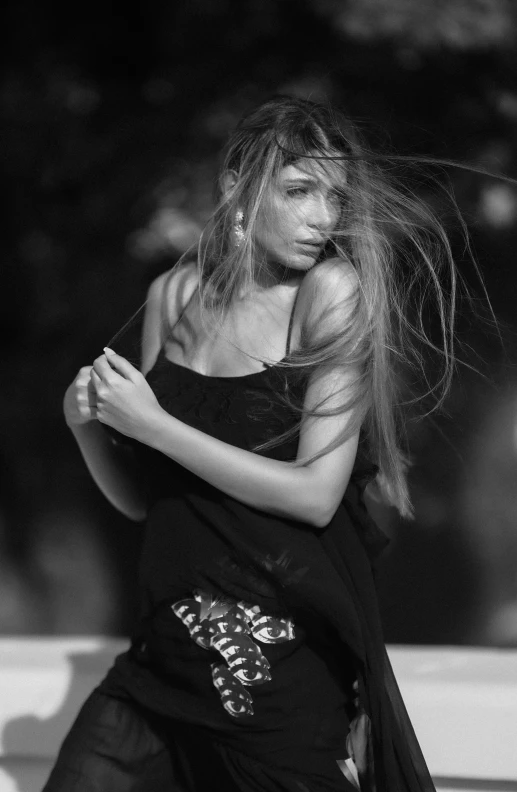 a beautiful woman with long hair leaning on a rail