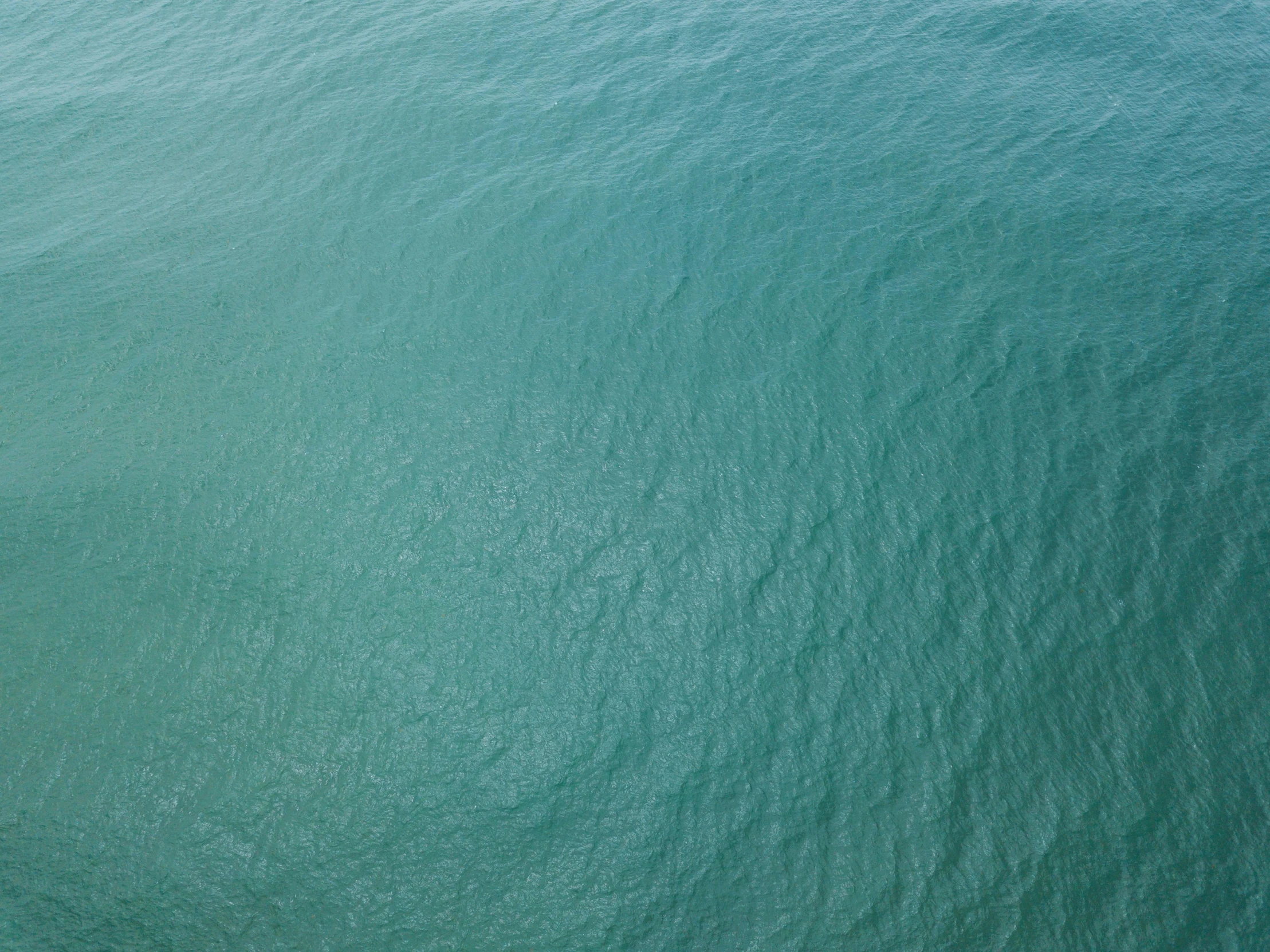 a small plane is floating over the blue water