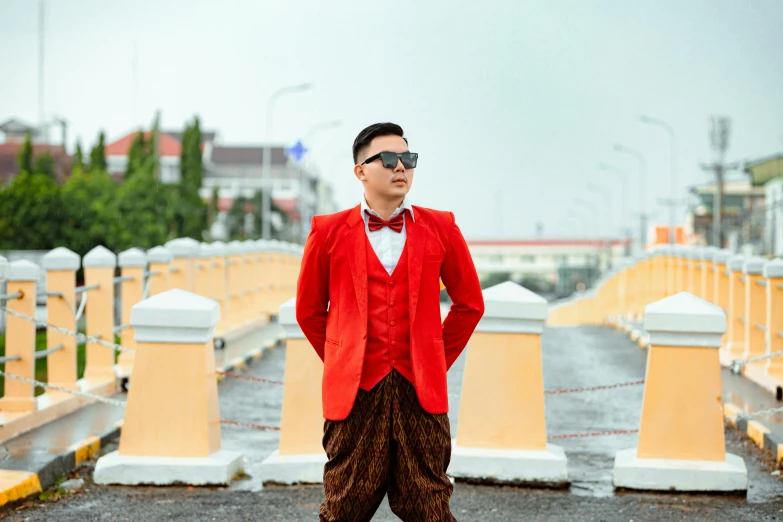 a man standing in the rain with a red jacket