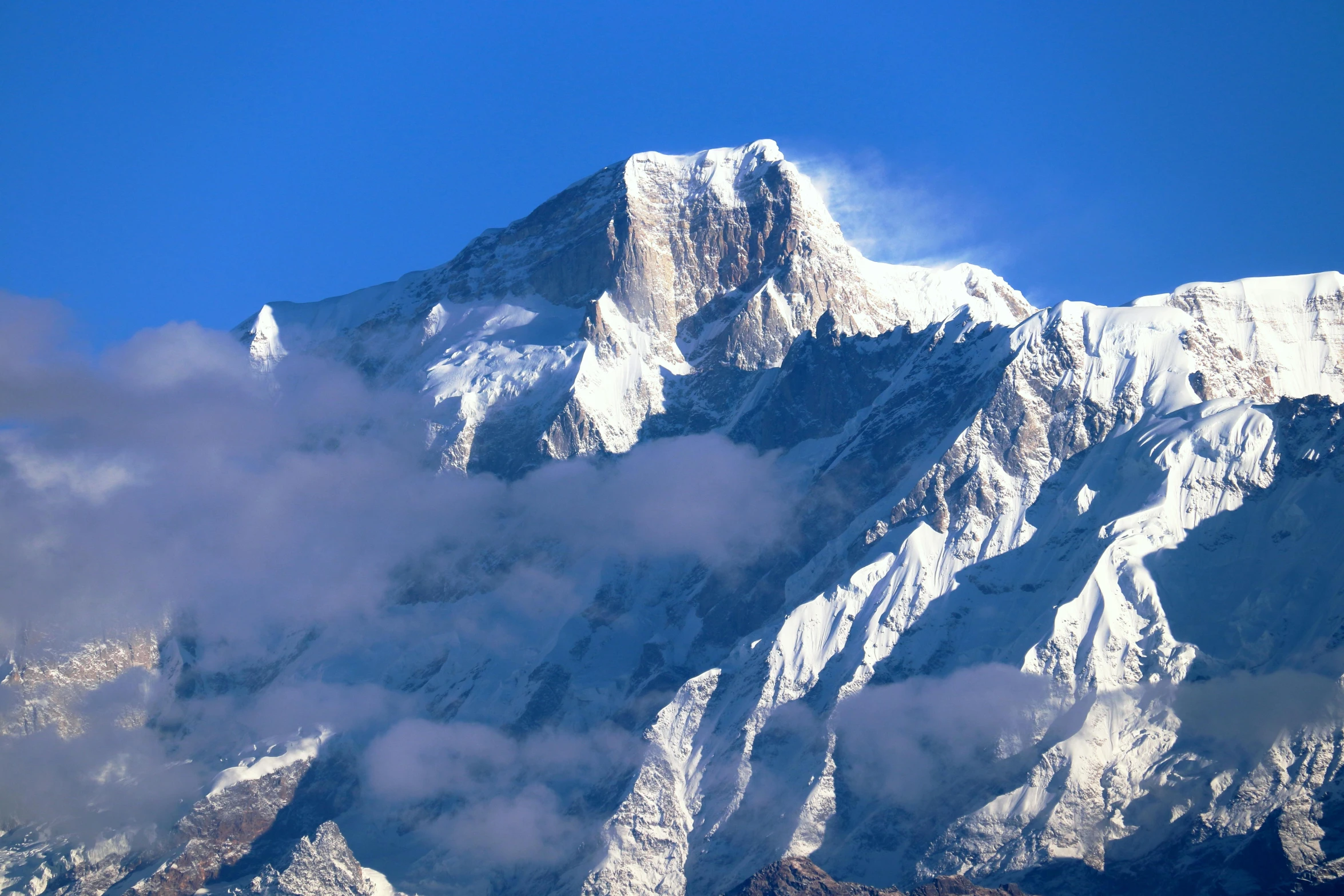 a mountain is covered with clouds and snow