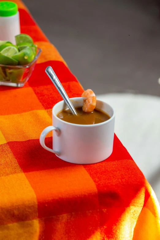 a cup of soup sitting on top of a table