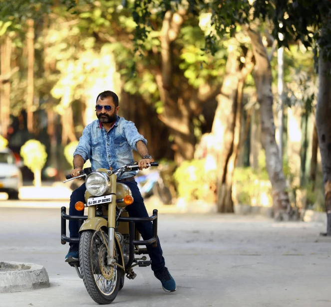 the man is riding on a motorbike down the street