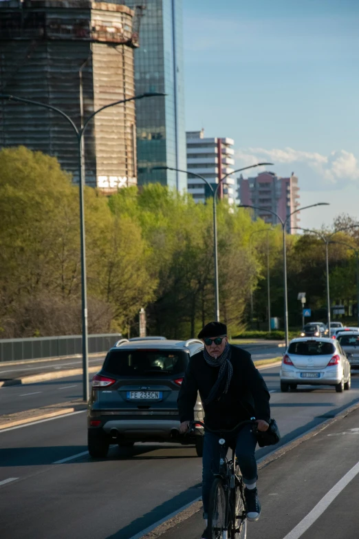 man riding his bicycle in the middle of the city