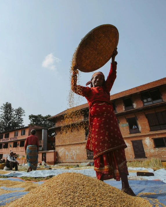 a woman is sprinkled with rice in an empty lot