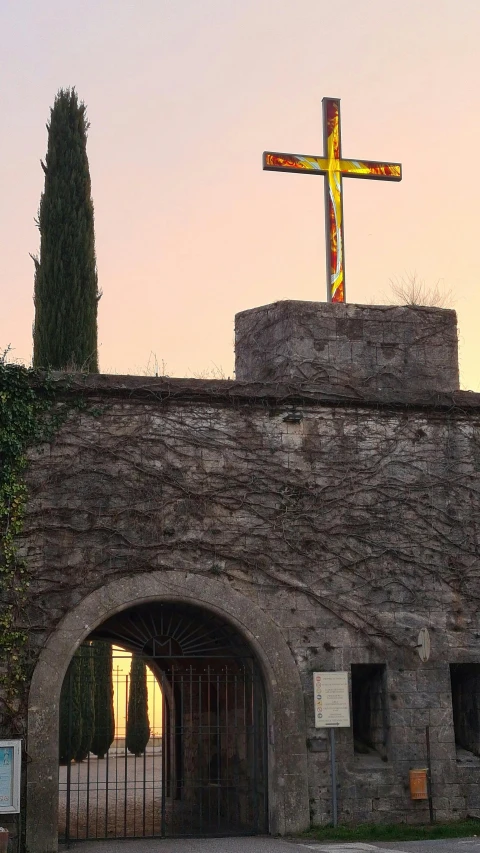 a large wooden cross on top of a stone wall