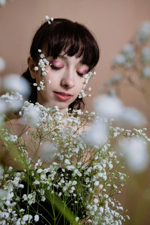 a woman is seen through the flowers