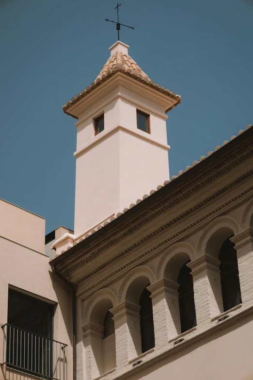 a large white building with an ornate roof and clock tower