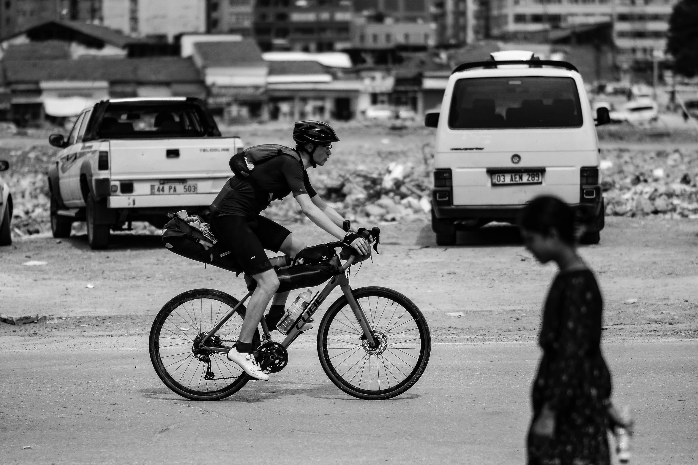 a black and white po of a person riding on a bike