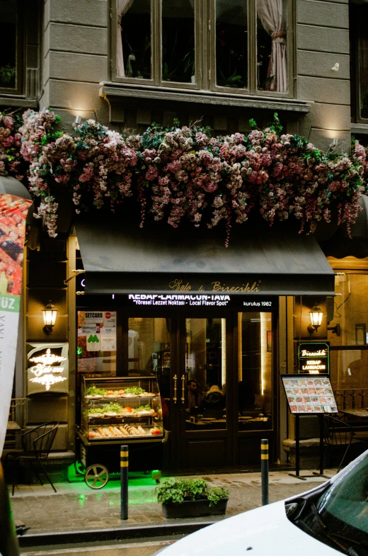 a window that has flowers hanging from it