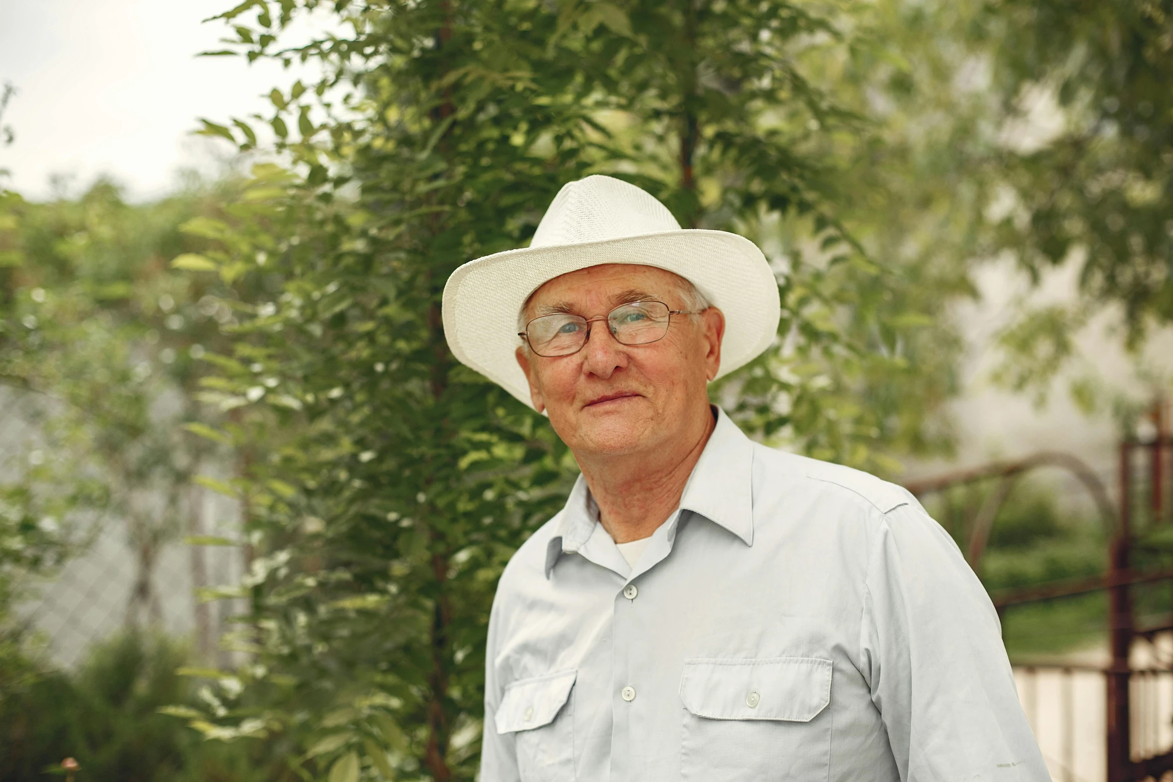 a man wearing a white hat and glasses