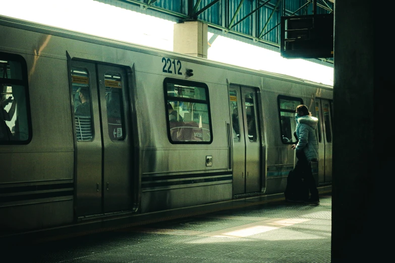 a woman standing at the entrance of a train