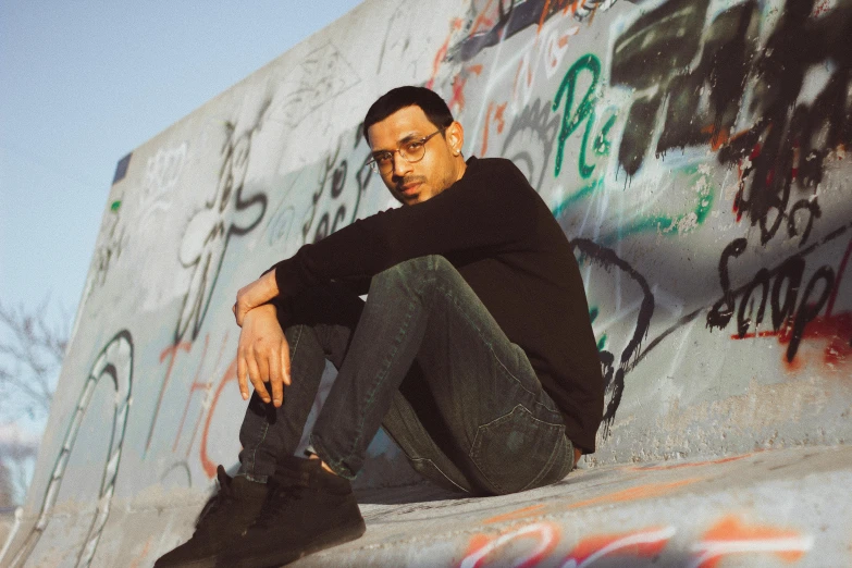 a skateboarder is posing on the wall