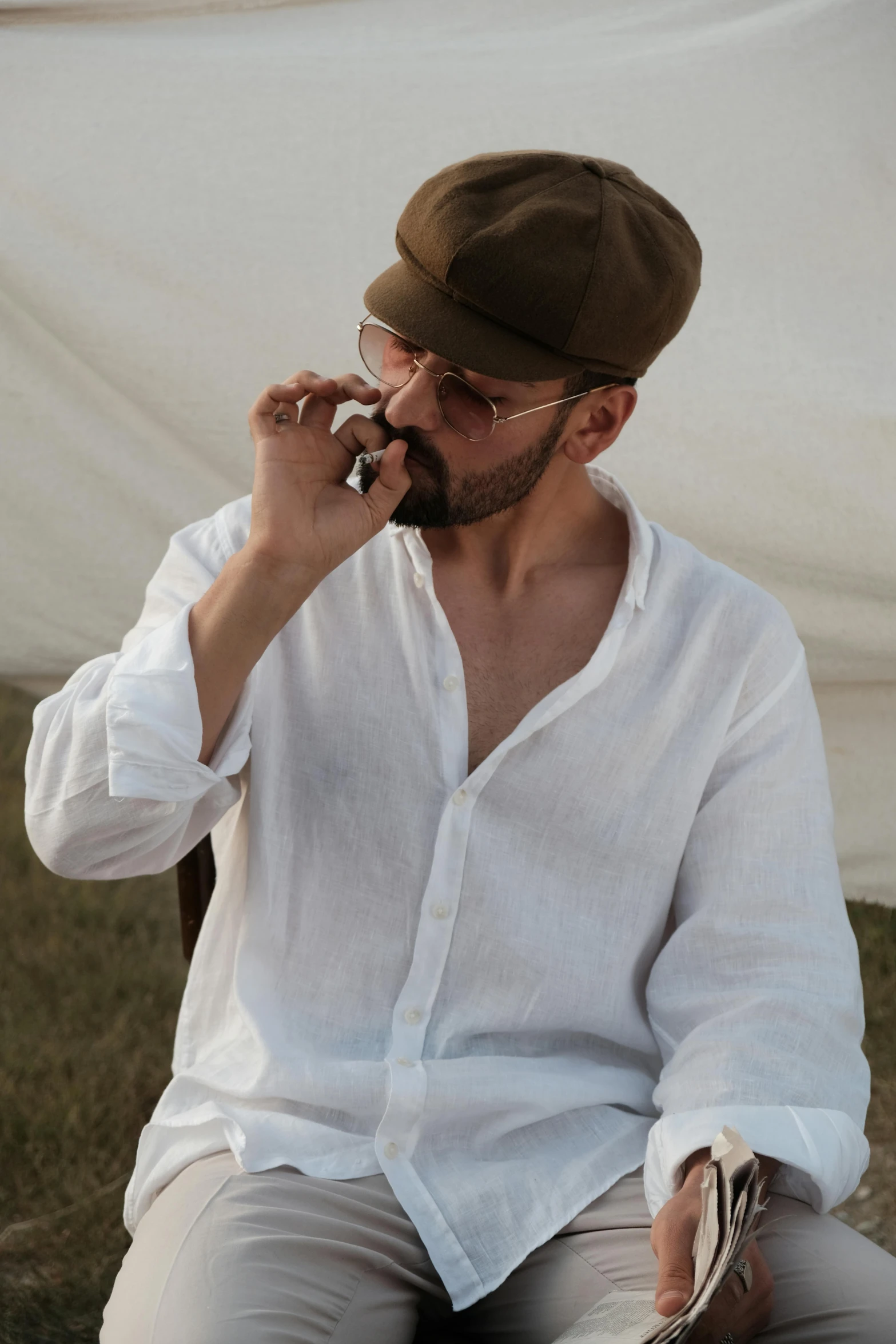 a man sitting in a chair talking on the phone