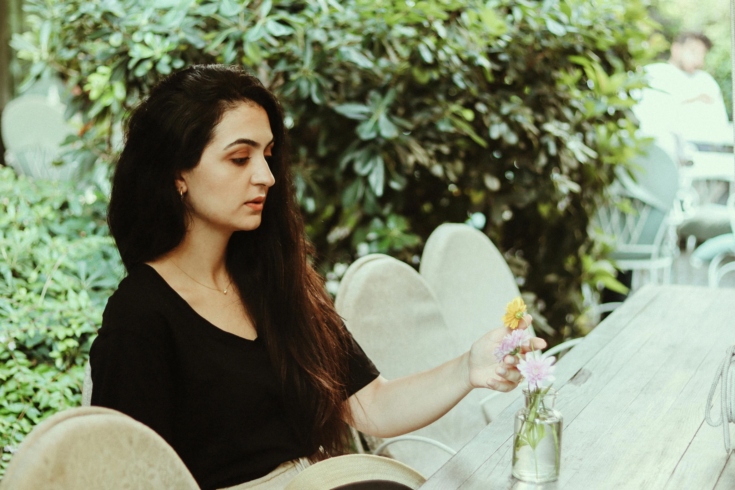 a girl is holding a bouquet of flowers in her hand