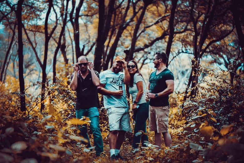 a group of friends posing for a po with trees in the background