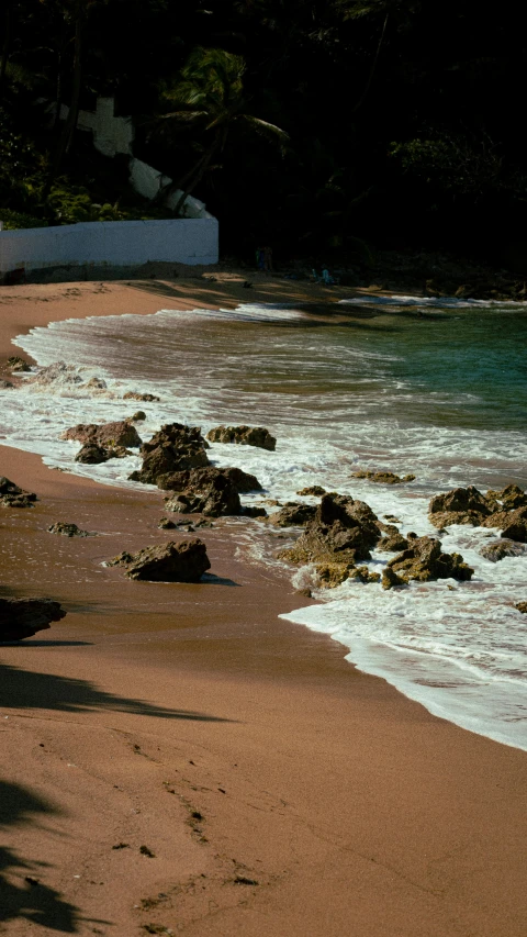 a beach with waves coming in and going into the shore