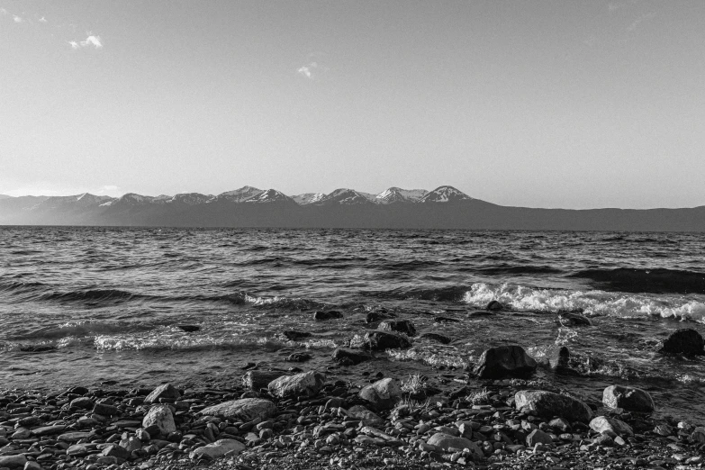 the water is low as it sits on the rocky shore