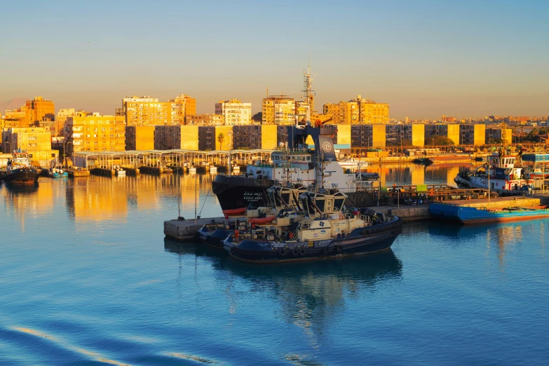 a large boat docked in the harbor in front of a city