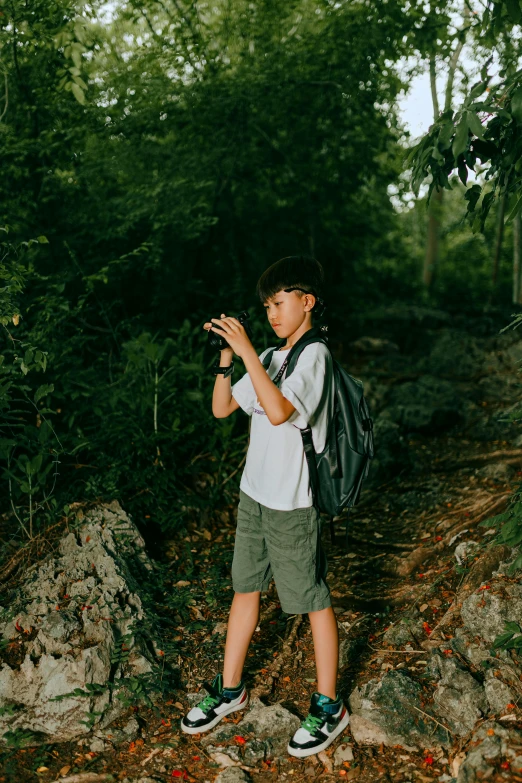 a boy standing with his backpack on his back