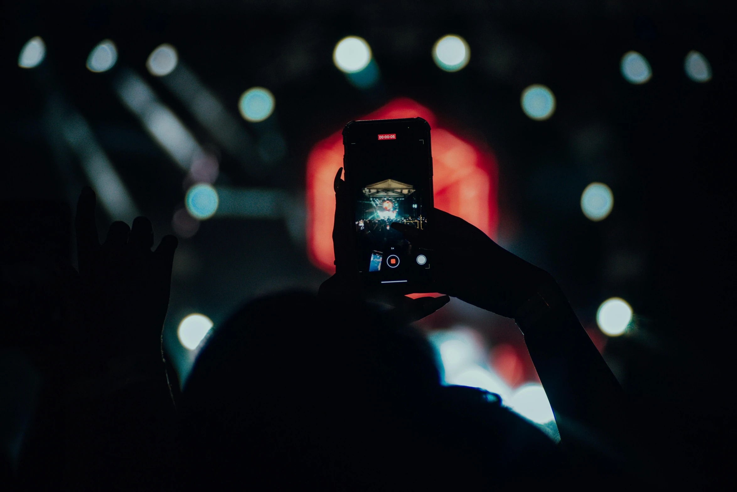 a person taking a picture with a cell phone