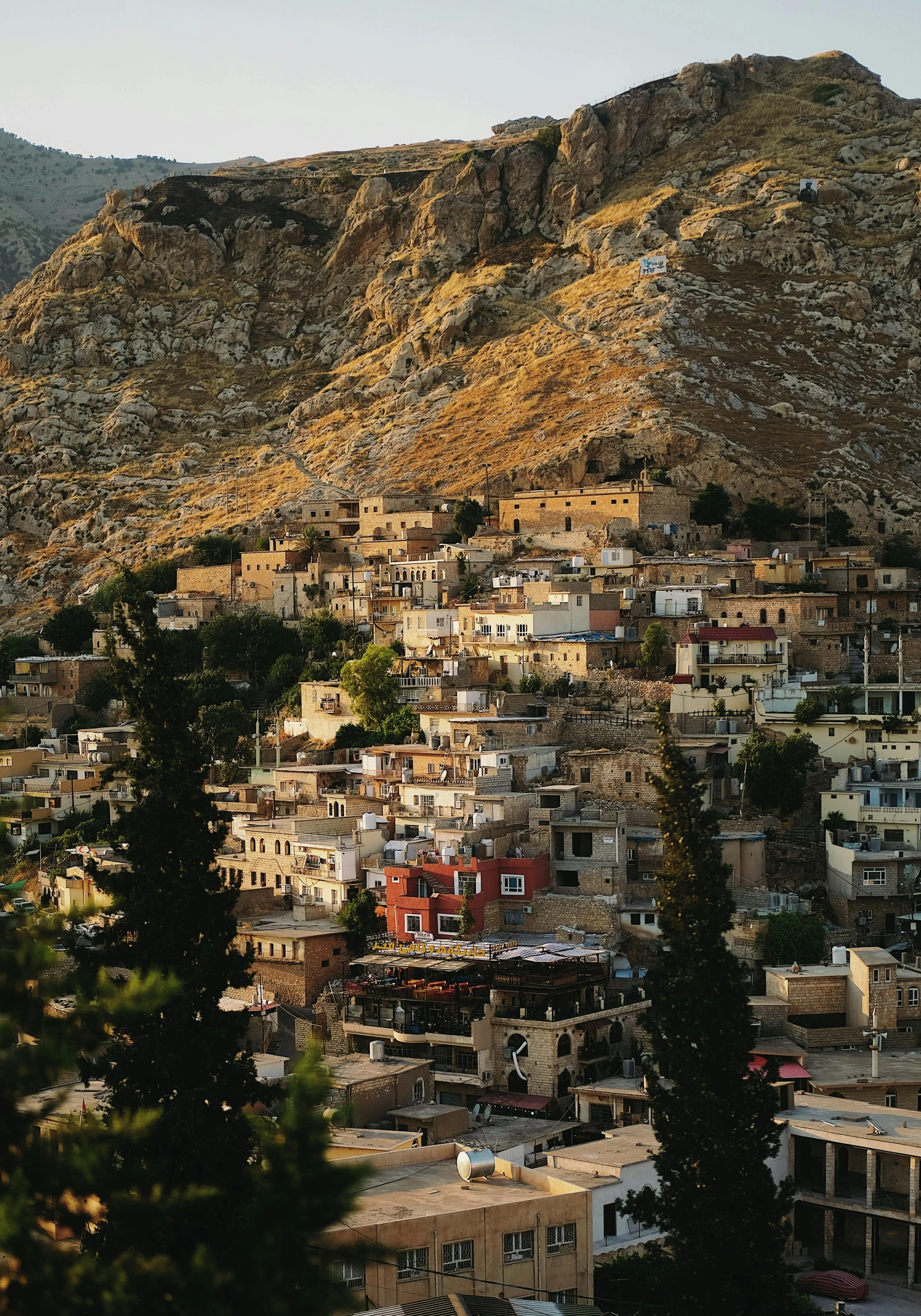 city below mountains at sunset or sundown